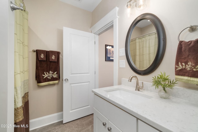 bathroom featuring vanity and baseboards