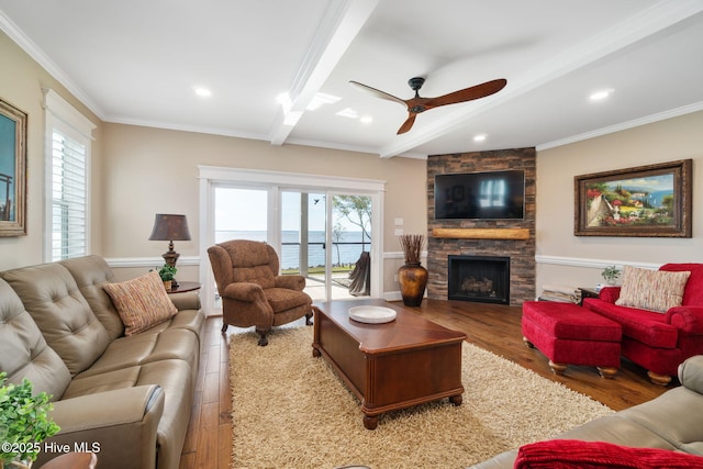 living area with crown molding, wood finished floors, a fireplace, ceiling fan, and recessed lighting