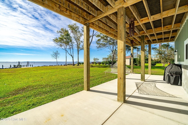 view of patio with a water view