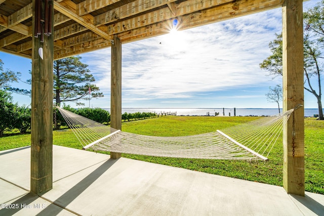 view of yard featuring a water view and a patio area