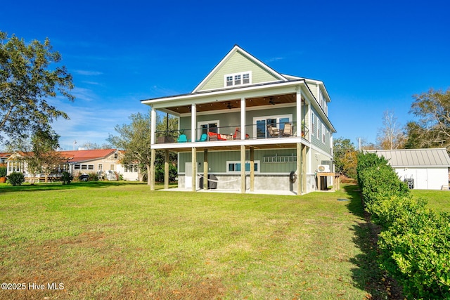 rear view of house with a lawn, a patio, a ceiling fan, and a balcony