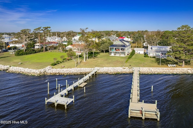 dock area with a water view and a yard