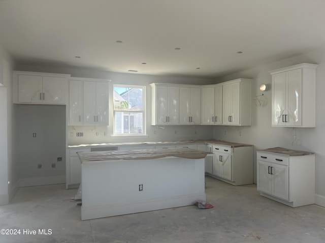 kitchen with white cabinetry and a kitchen island