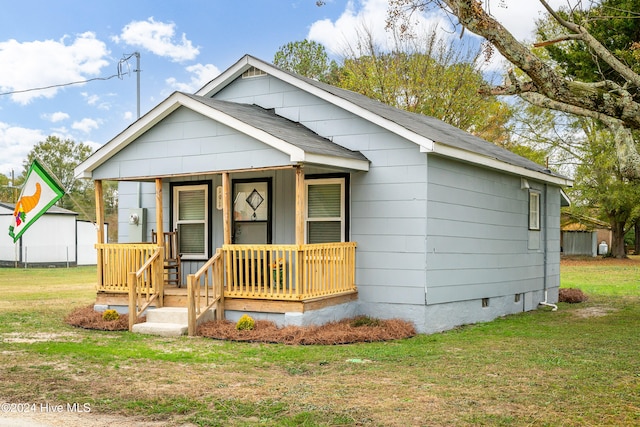 bungalow with covered porch and a front yard