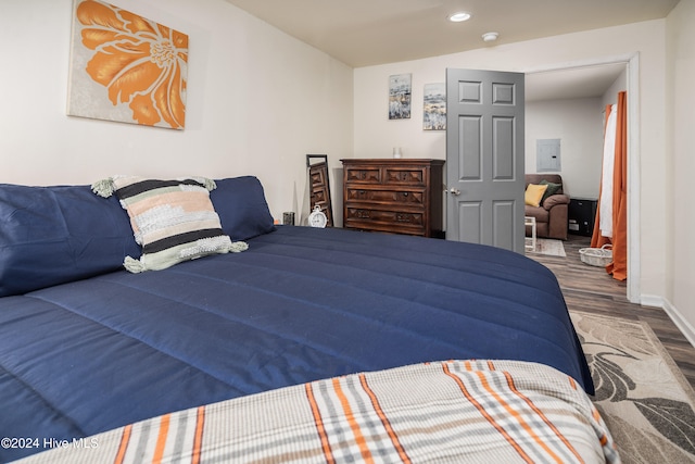 bedroom with dark hardwood / wood-style floors