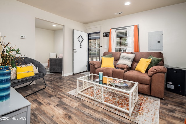 living room with dark hardwood / wood-style flooring and electric panel