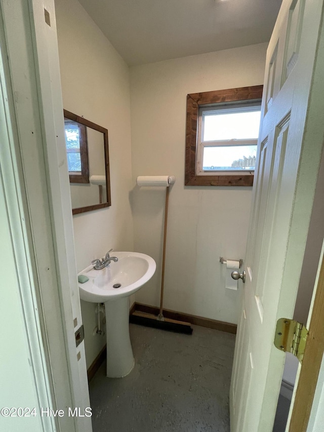 bathroom with concrete floors and baseboards