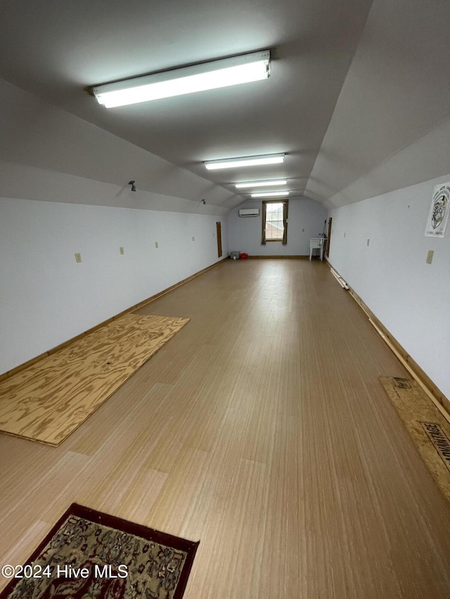 bonus room with vaulted ceiling and wood finished floors