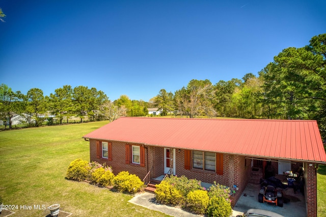 single story home featuring metal roof, a front lawn, and brick siding