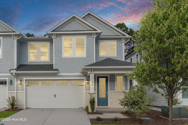 3146 Painted Turtle Loop Unit 12, Wilmington, NC 28409 - view of front facade with concrete driveway, an attached garage, and a shingled roof
