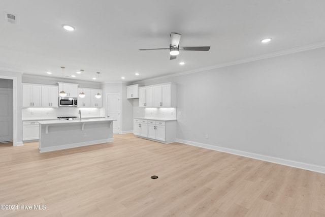 3146 Painted Turtle Loop Unit 12, Wilmington, NC 28409 - kitchen with stainless steel microwave, tasteful backsplash, ceiling fan, open floor plan, and recessed lighting