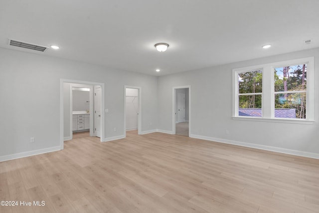 3146 Painted Turtle Loop Unit 12, Wilmington, NC 28409 - unfurnished bedroom featuring light wood-style floors, a spacious closet, baseboards, and recessed lighting