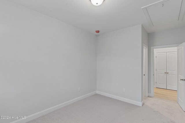 3146 Painted Turtle Loop Unit 12, Wilmington, NC 28409 - unfurnished room with light carpet, baseboards, and attic access