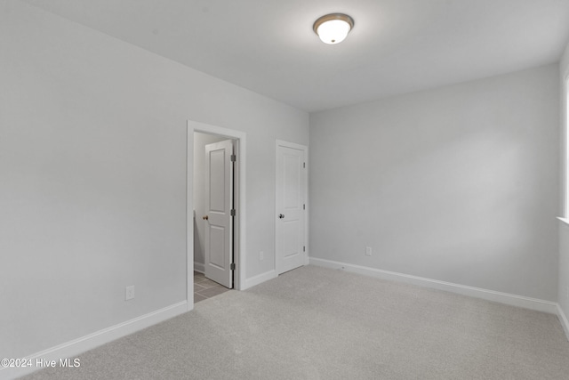 unfurnished bedroom with light colored carpet