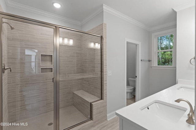 bathroom with wood-type flooring, vanity, toilet, and crown molding