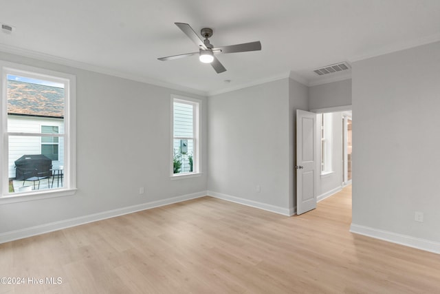 unfurnished room with light wood-type flooring, plenty of natural light, ornamental molding, and ceiling fan