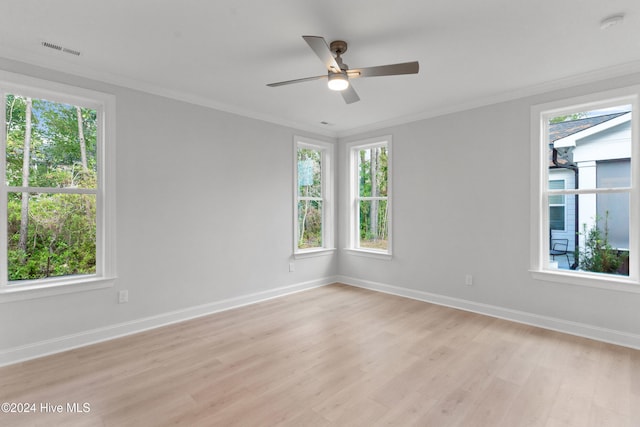 spare room featuring a wealth of natural light and light hardwood / wood-style floors