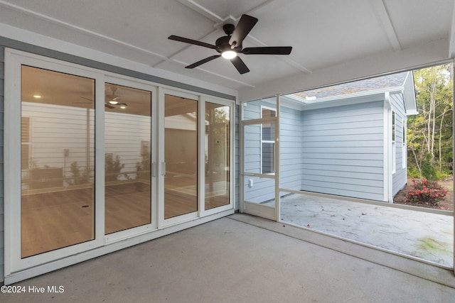 unfurnished sunroom featuring ceiling fan