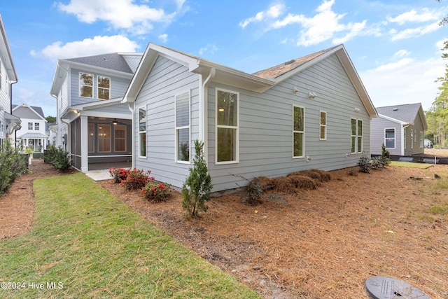 3146 Painted Turtle Loop Unit 12, Wilmington, NC 28409 - view of home's exterior featuring a sunroom and a lawn