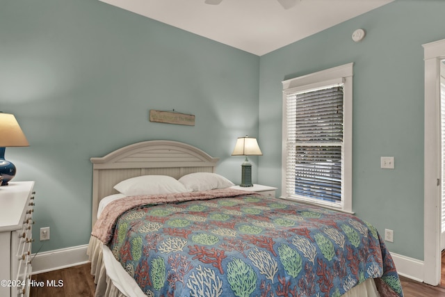 221 Seawatch Way, Kure Beach, NC 28449 - bedroom with wood finished floors, baseboards, and a ceiling fan