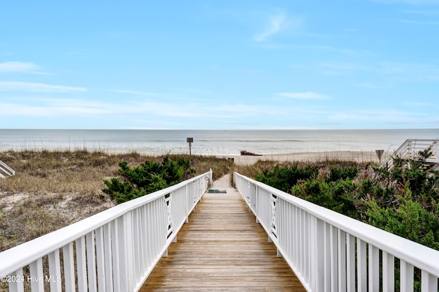 view of home's community with a beach view and a water view