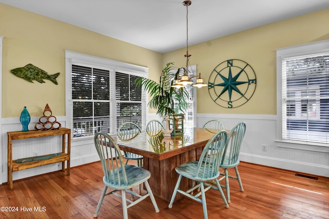 dining space with a chandelier, hardwood / wood-style floors, and plenty of natural light