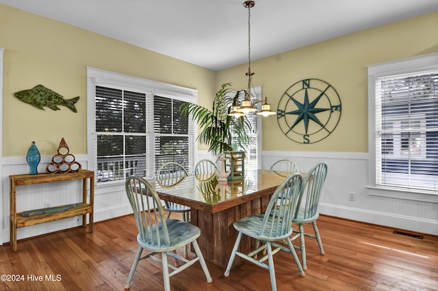 221 Seawatch Way, Kure Beach, NC 28449 - dining space with wainscoting, wood finished floors, and a chandelier