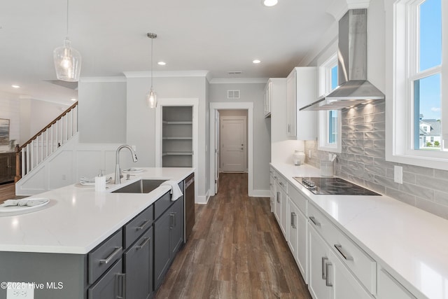 513 Moss Lake Ln, Holly Ridge, NC 28445 - kitchen featuring decorative backsplash, black electric stovetop, wall chimney range hood, white cabinets, and a sink