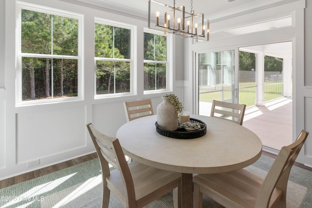 513 Moss Lake Ln, Holly Ridge, NC 28445 - dining room with a chandelier and wood finished floors