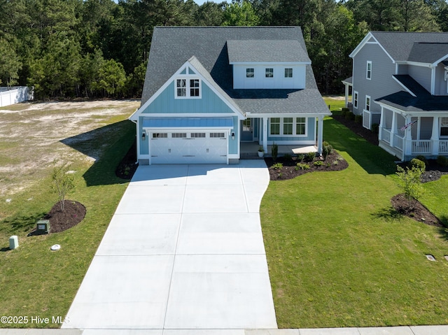 513 Moss Lake Ln, Holly Ridge, NC 28445 - view of front of home featuring board and batten siding, driveway, a garage, a front lawn, and a shingled roof