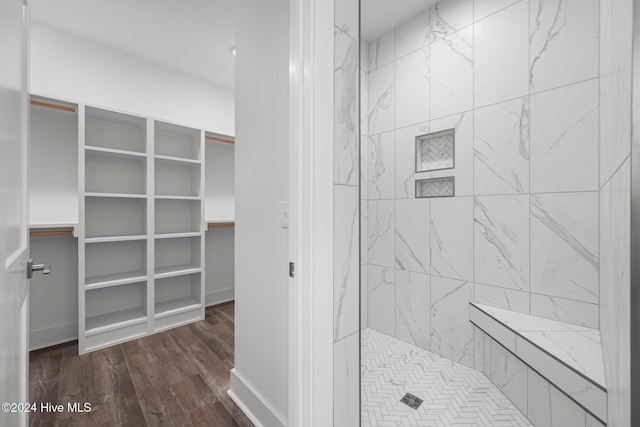 513 Moss Lake Ln, Holly Ridge, NC 28445 - full bathroom featuring a tile shower, wood finished floors, and a spacious closet