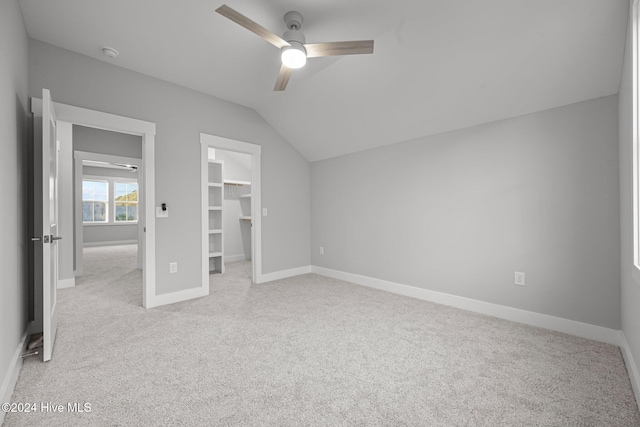 513 Moss Lake Ln, Holly Ridge, NC 28445 - unfurnished bedroom with baseboards, carpet, a walk in closet, and lofted ceiling