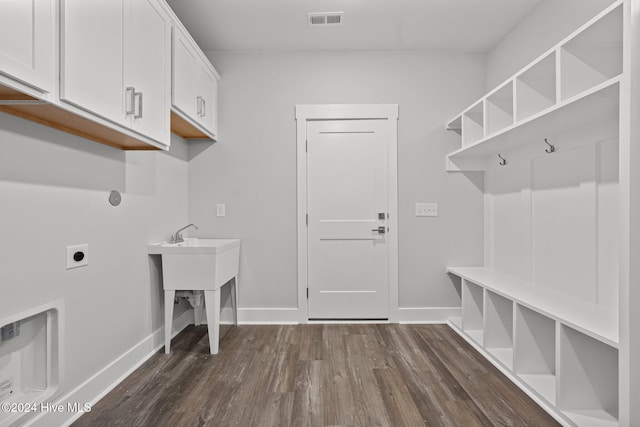 513 Moss Lake Ln, Holly Ridge, NC 28445 - clothes washing area featuring electric dryer hookup, visible vents, cabinet space, baseboards, and dark wood-style floors
