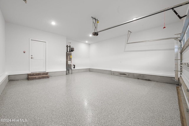 513 Moss Lake Ln, Holly Ridge, NC 28445 - garage featuring recessed lighting, a garage door opener, baseboards, and water heater