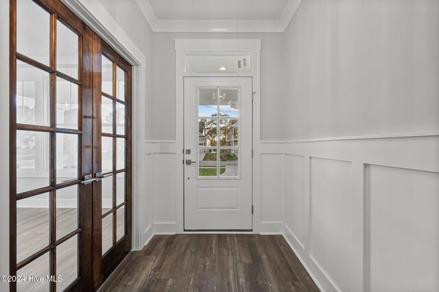 513 Moss Lake Ln, Holly Ridge, NC 28445 - doorway featuring french doors, dark wood-style flooring, a decorative wall, and wainscoting