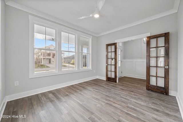 513 Moss Lake Ln, Holly Ridge, NC 28445 - empty room with french doors, ornamental molding, ceiling fan, and wood finished floors