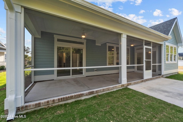 513 Moss Lake Ln, Holly Ridge, NC 28445 - rear view of property with roof with shingles, a patio, and a sunroom