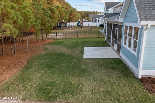 513 Moss Lake Ln, Holly Ridge, NC 28445 - view of yard featuring a patio, fence, and a playground