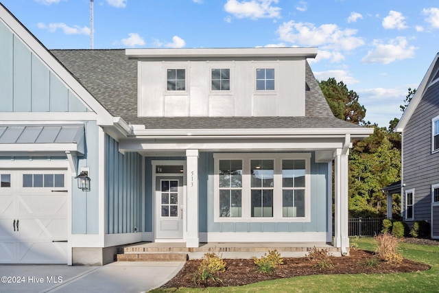 513 Moss Lake Ln, Holly Ridge, NC 28445 - view of front of house featuring fence, a shingled roof, an attached garage, board and batten siding, and a porch