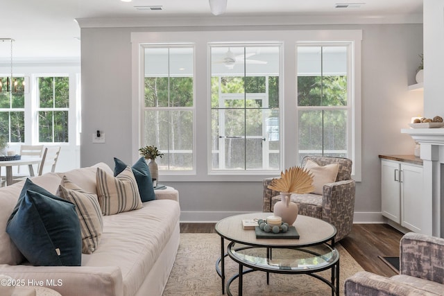 513 Moss Lake Ln, Holly Ridge, NC 28445 - living area with crown molding, baseboards, dark wood-style floors, and visible vents