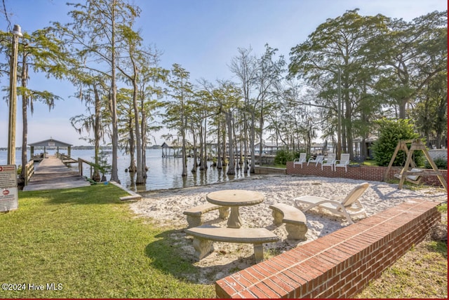 exterior space with a dock and a water view