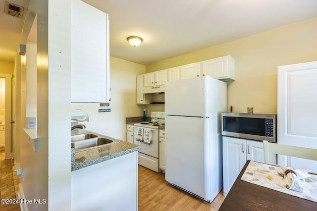 kitchen featuring sink, light hardwood / wood-style flooring, dark stone counters, white appliances, and white cabinets