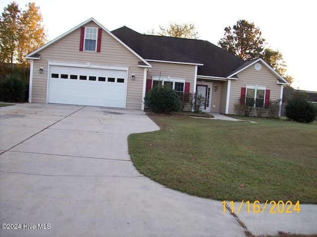 view of front of home with a garage and a front yard