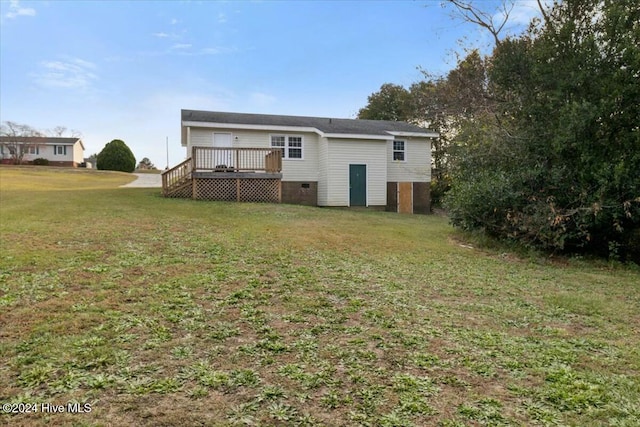 rear view of house with a lawn and a deck