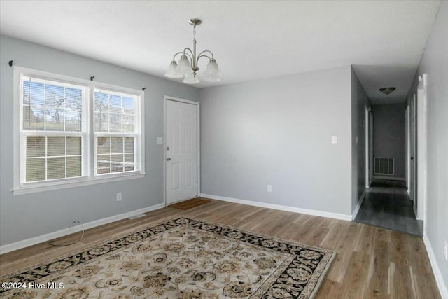 interior space featuring hardwood / wood-style floors and a notable chandelier