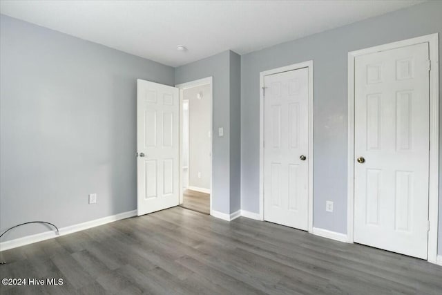 unfurnished bedroom featuring dark wood-type flooring