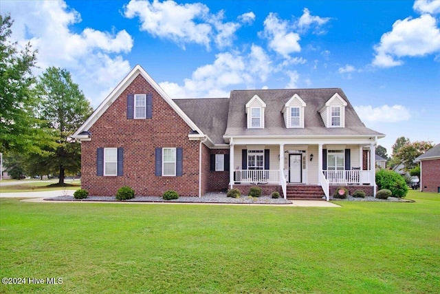 cape cod home with a porch and a front yard