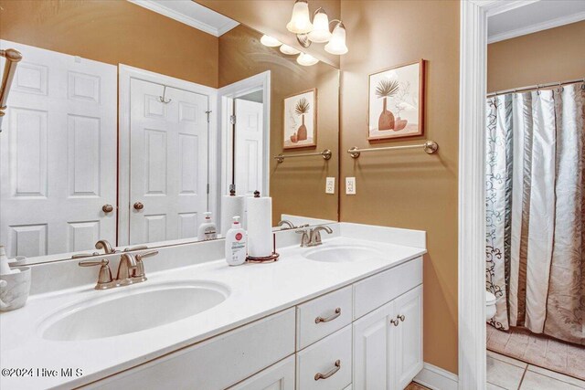 bathroom with vanity, tile patterned floors, crown molding, toilet, and a notable chandelier