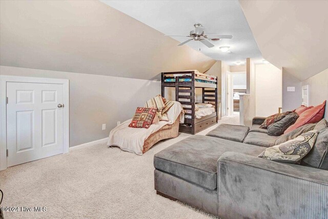 living room featuring ceiling fan, carpet, and lofted ceiling