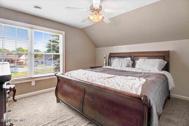 carpeted bedroom featuring ceiling fan and vaulted ceiling